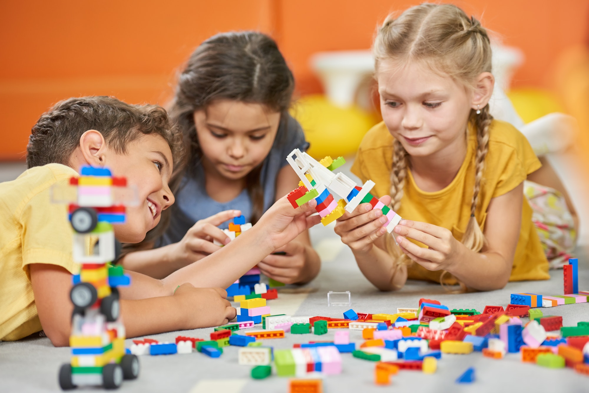 group-of-kids-playing-with-plastic-blocks-